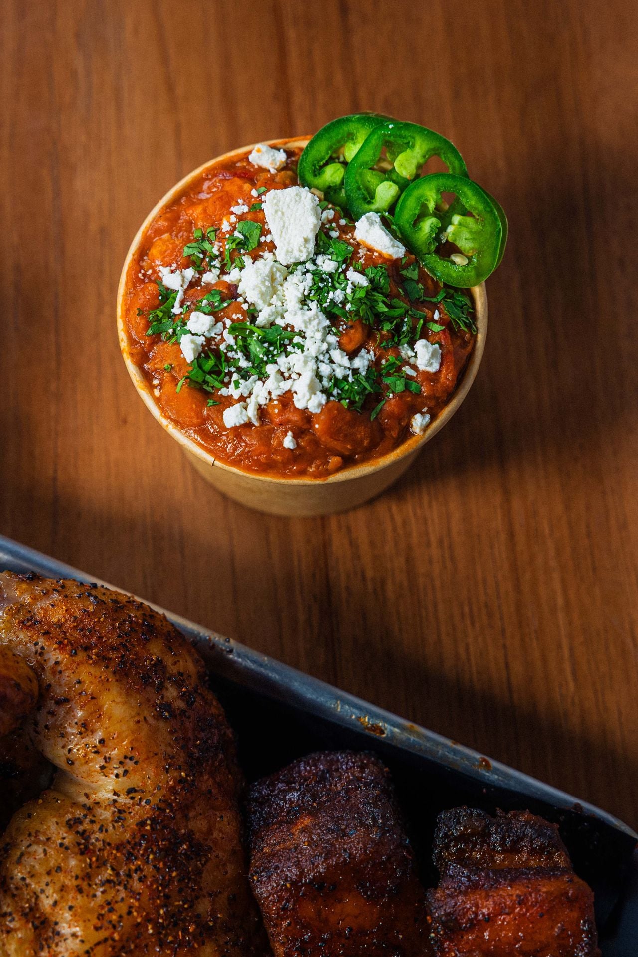 A cup of charro beans topped with cotija cheese