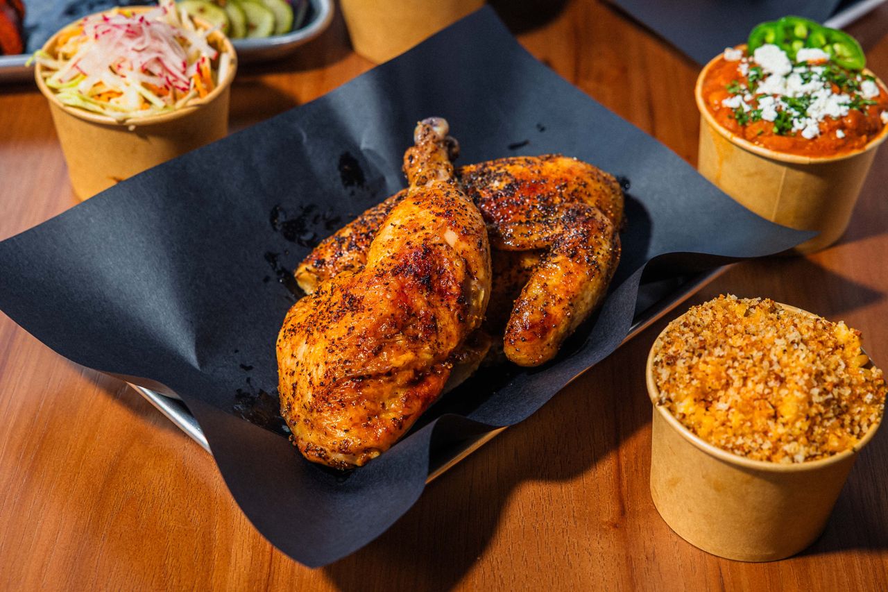 Smoked chicken surrounded by side dishes
