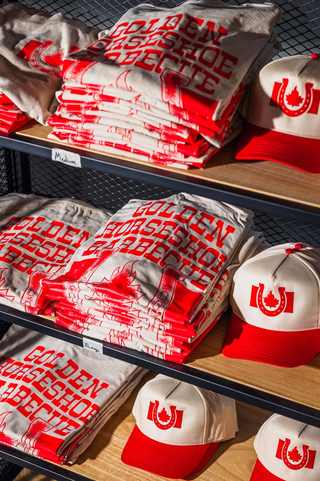 Shelves are lined with Golden Horseshoe Barbecue shirts and hats
