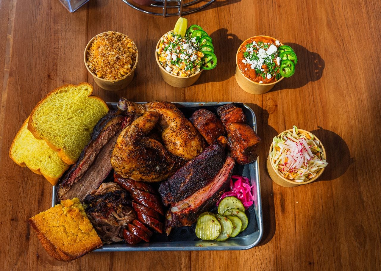 A platter of barbecue, surrounded by side dishes
