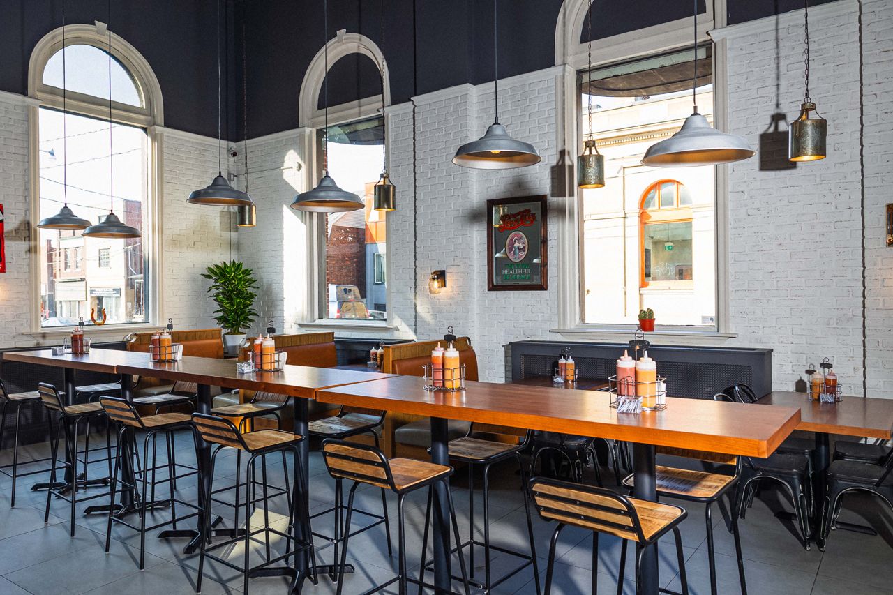 Communal dining tables inside Golden Horseshoe Barbecue