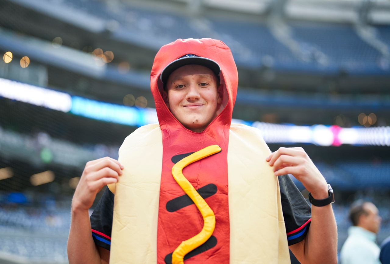 A Blue Jays fan wearing a hot dog costume