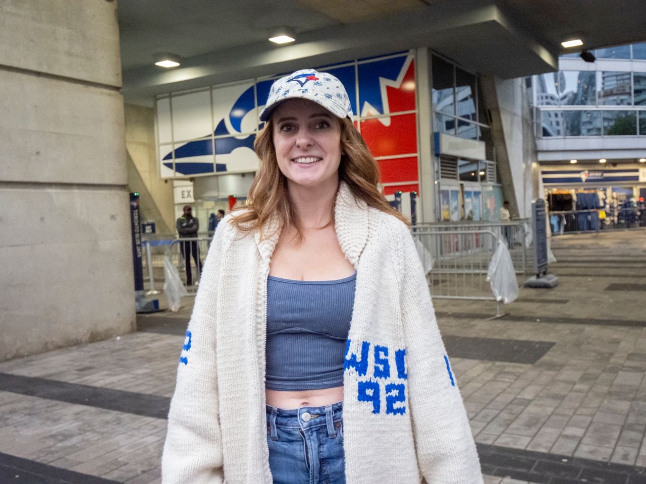 Woman wearing vintage knit Blue Jays sweater.