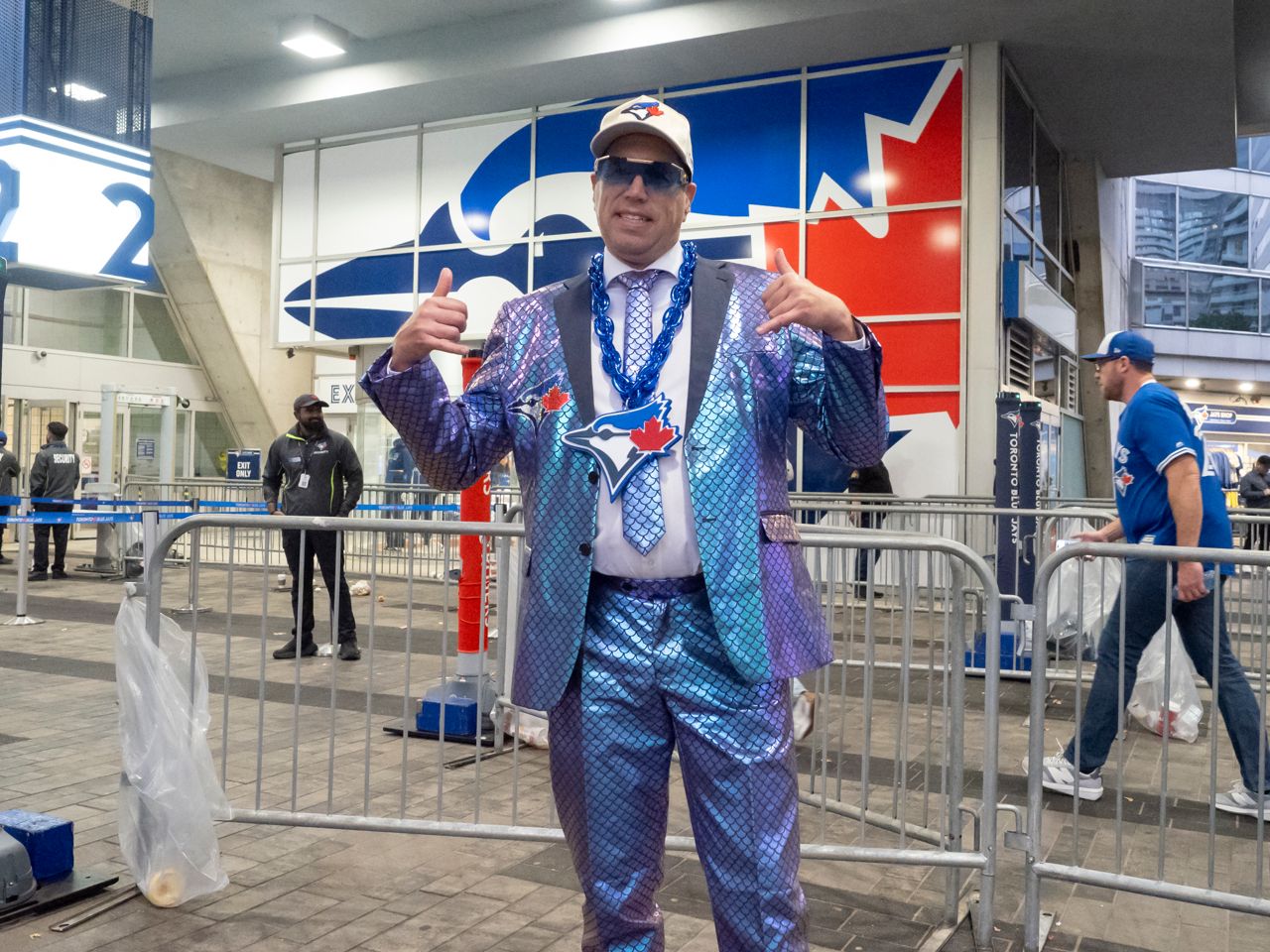 Man wearing shiny fish scale suit.