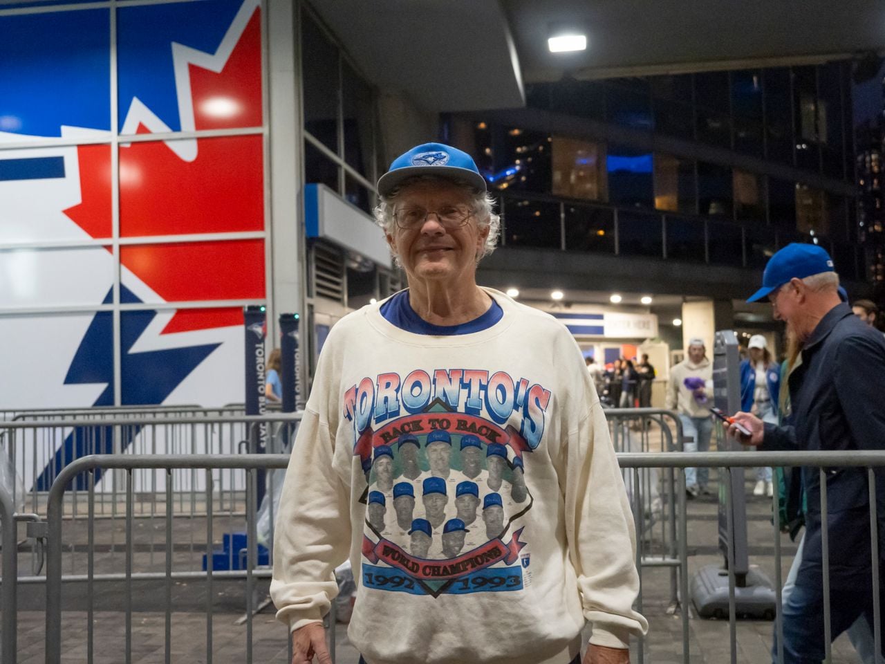 Older man in vintage Blue Jays sweatshirt.