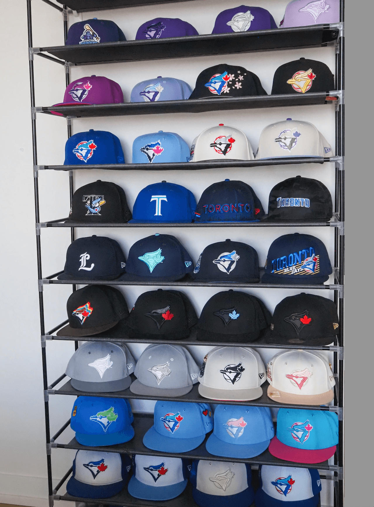 A wall of Blue Jays hats