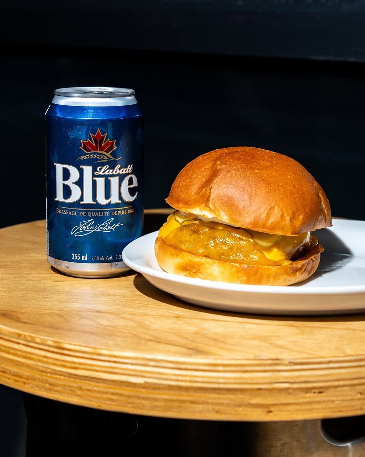 A can of Labatt Blue and a burger at Dotty's in Toronto