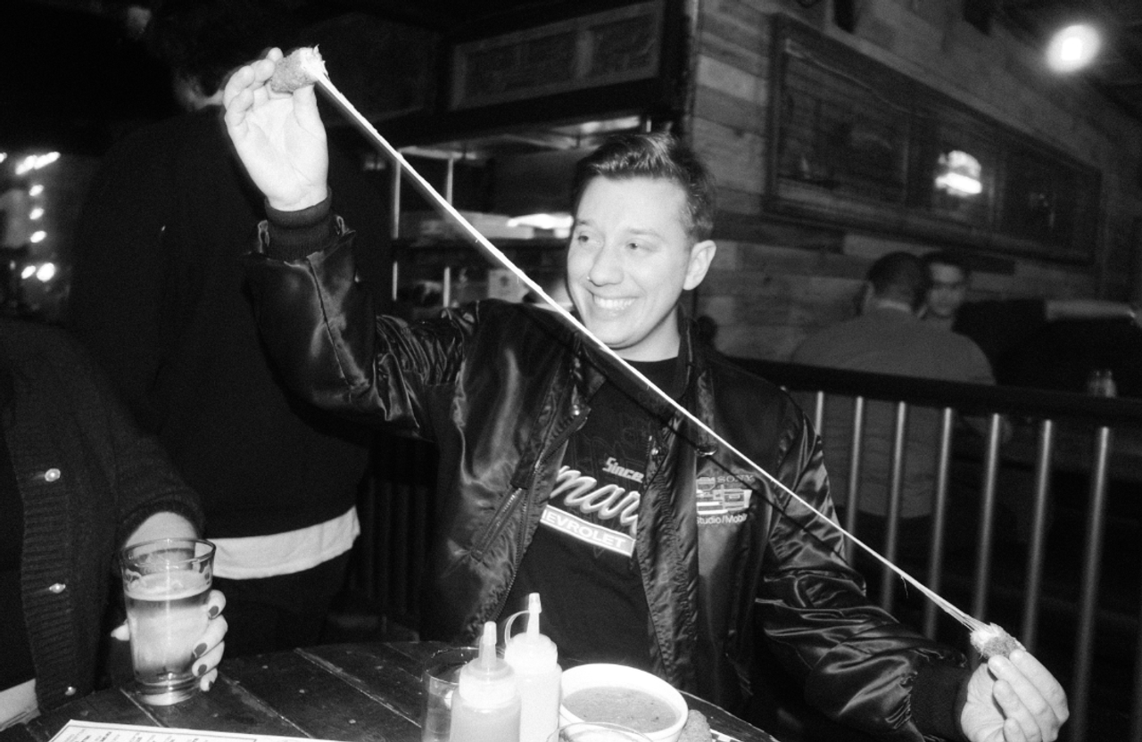 A person pulls a mozzarella stick in two