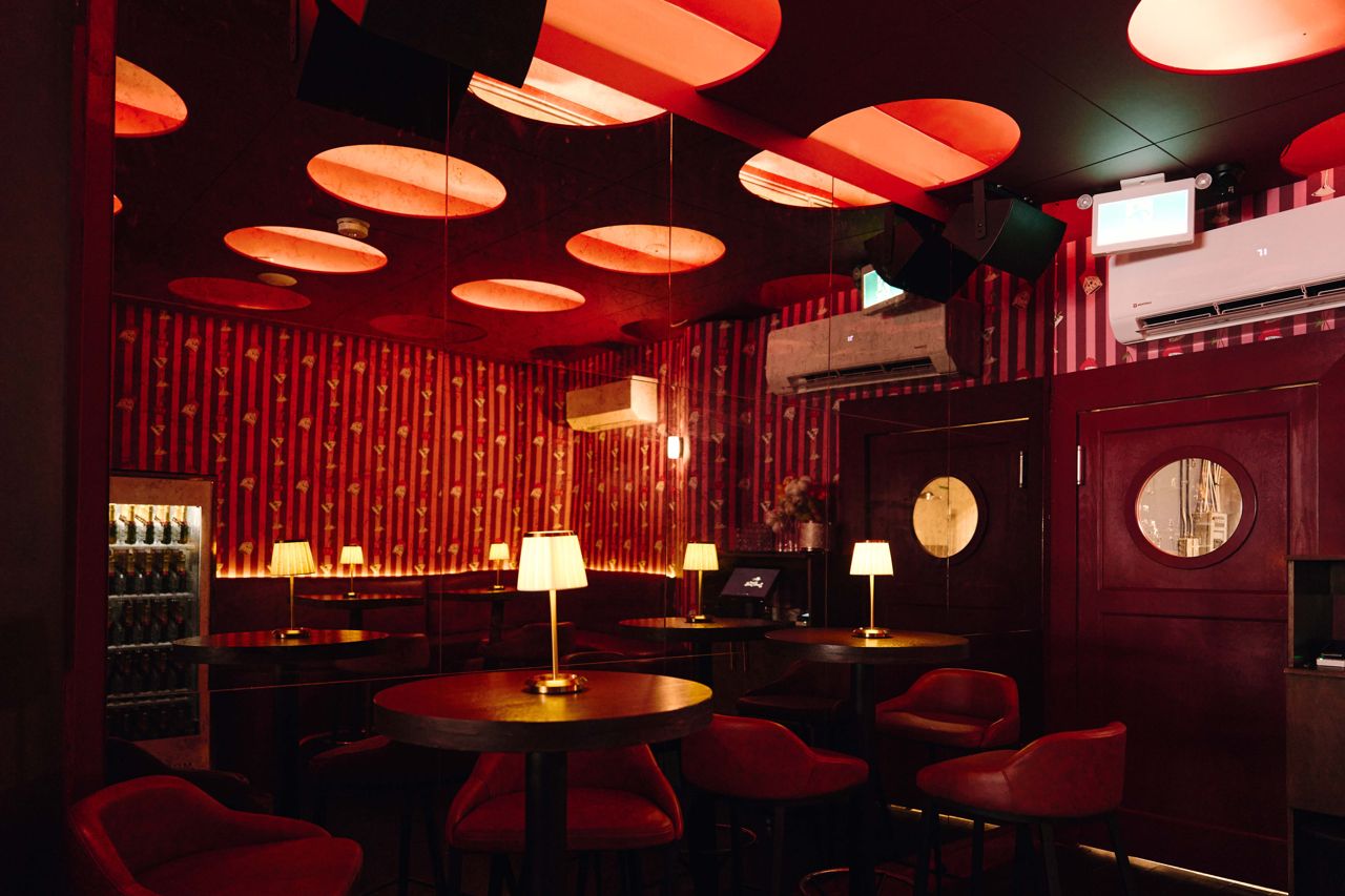The dark and moody dining room at Small Talk, a martini bar and jazz lounge
