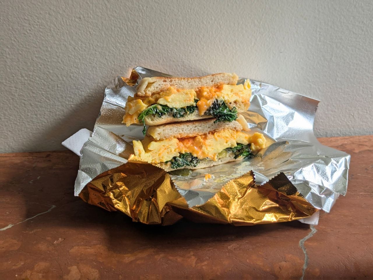 A closeup of Gold Standard's breakfast sandwich with kale