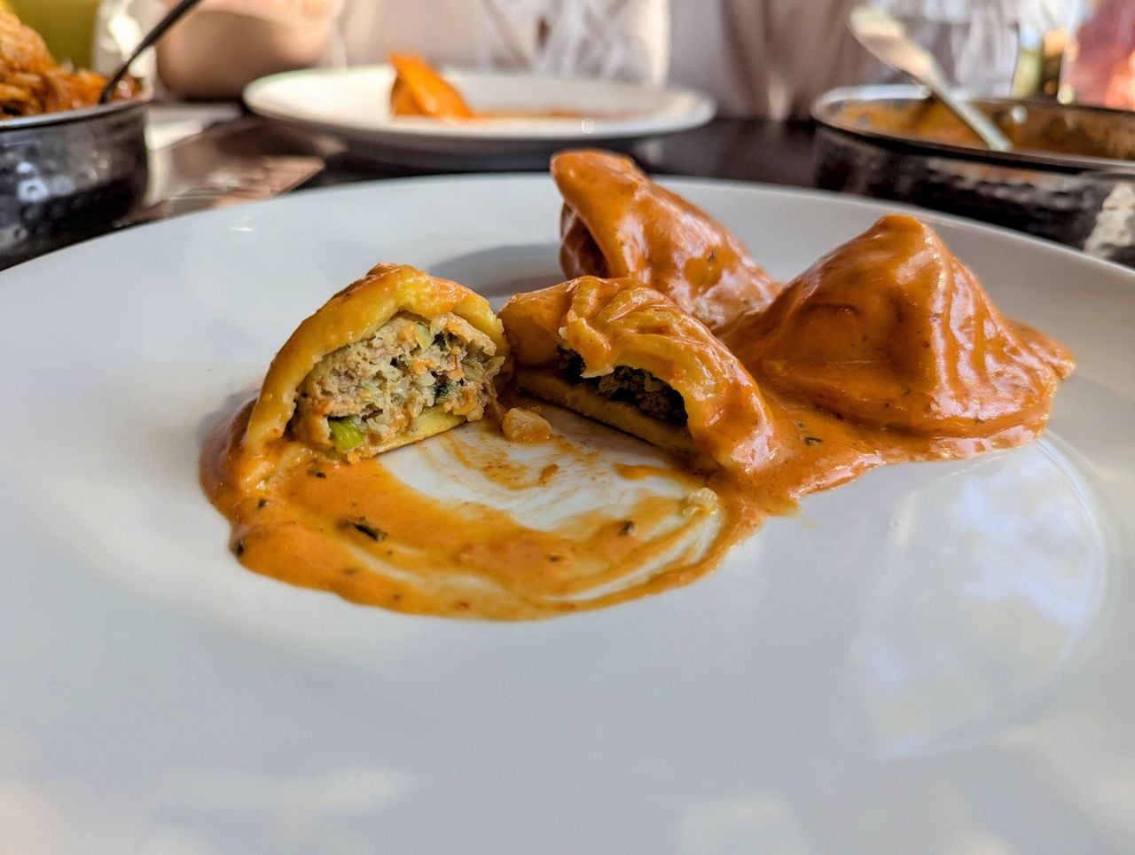 A closeup of the butter chicken momos at Himalayan Kitchen