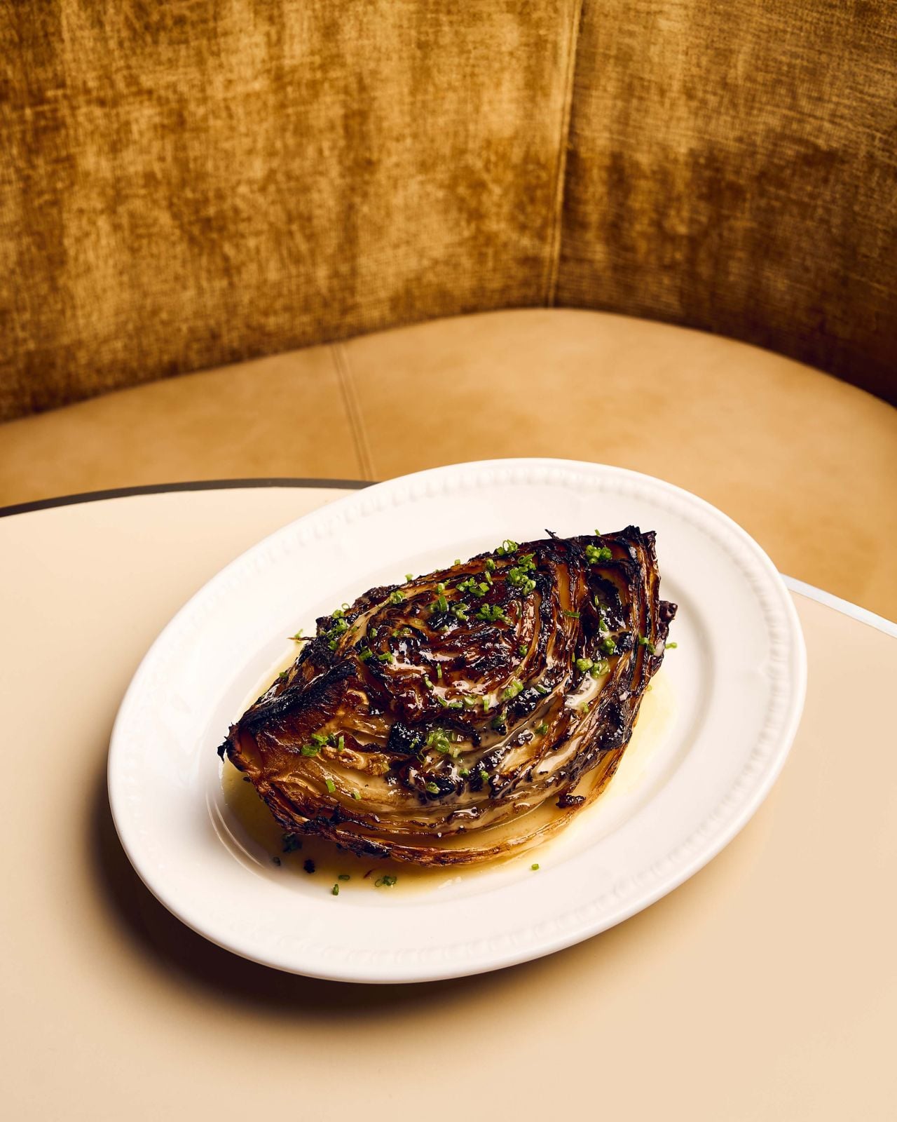 Hajare builds his own vegetarian XO sauce from shiitake and maitake trims, stuffs it into steamed cabbage, ties it with koji butter, then bakes it until it develops a crust