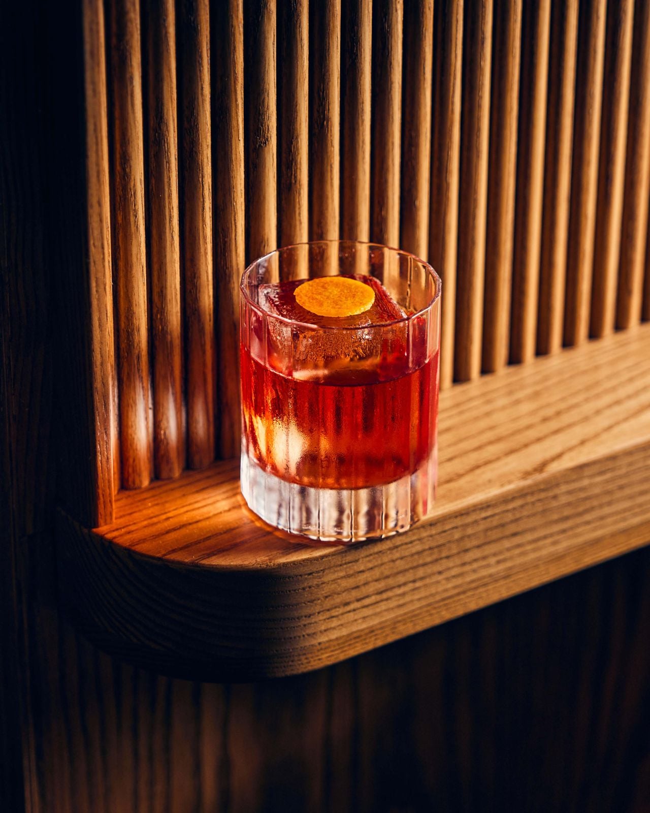 A negroni on a bar ledge
