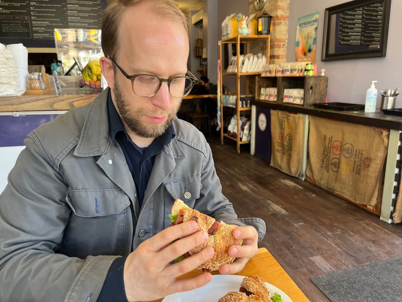 Chef Daniel Hyam picks up a bagel BLT