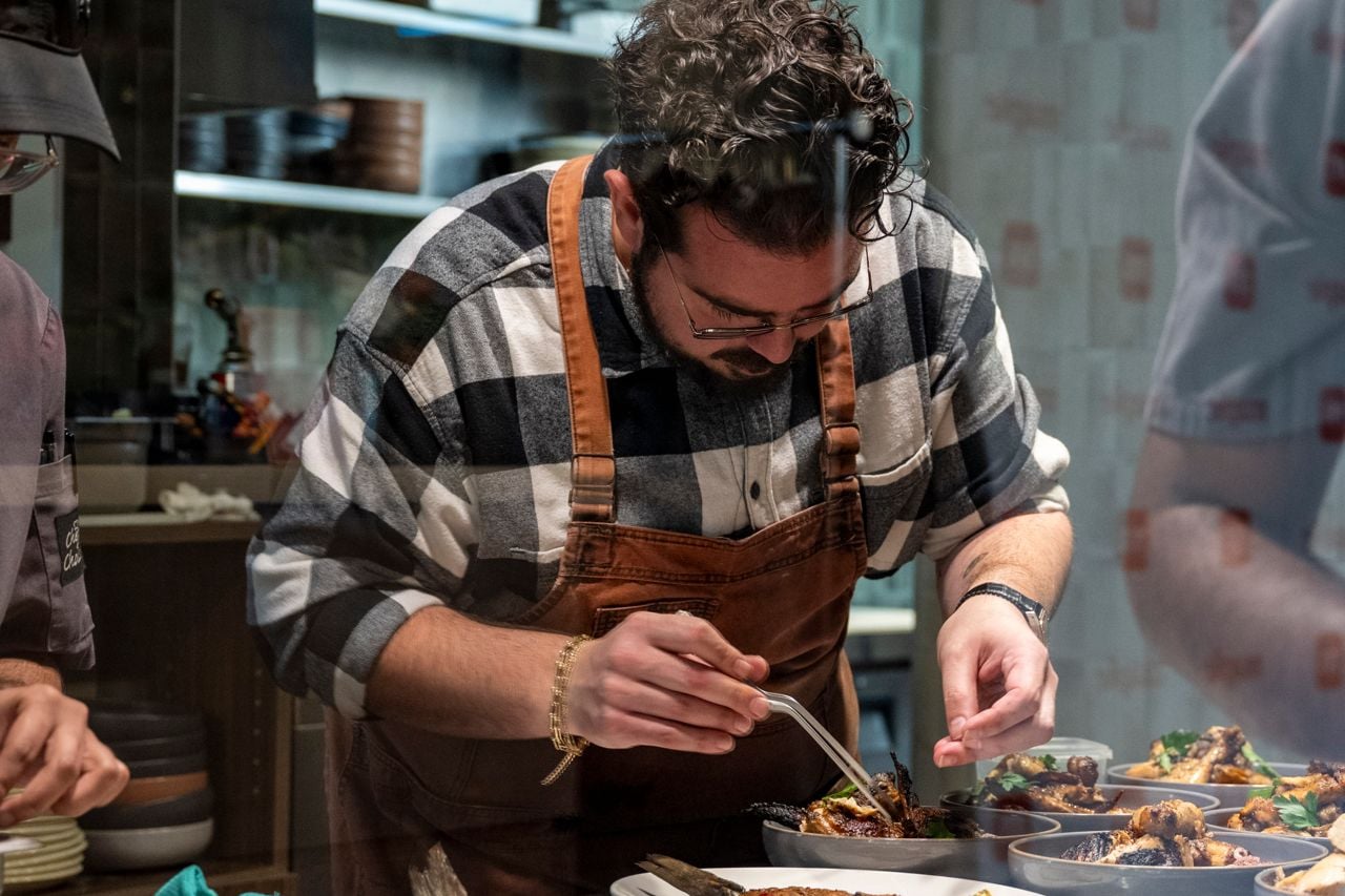 Chef Seb Yacoubian, chef and co-owner of Taline, preparing dishes for the event's guests