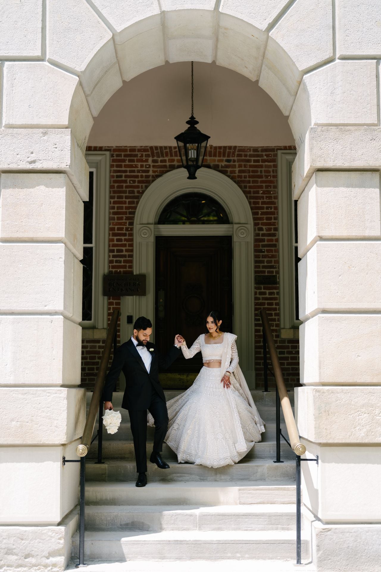 Bride and groom walking down stairs