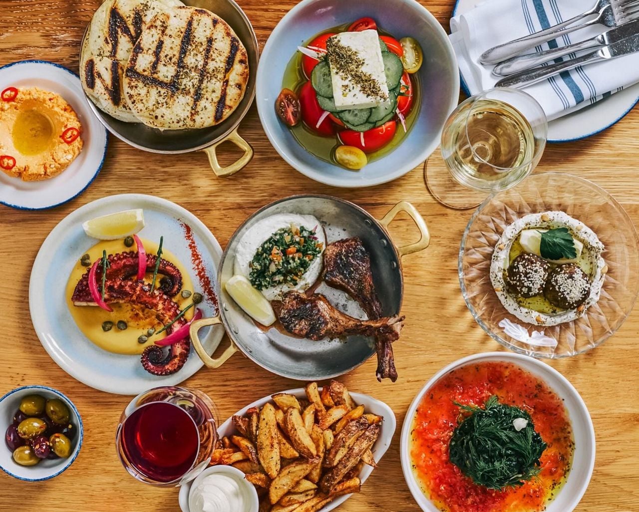 A spread of Greek dishes and drinks at Mamakas Taverna