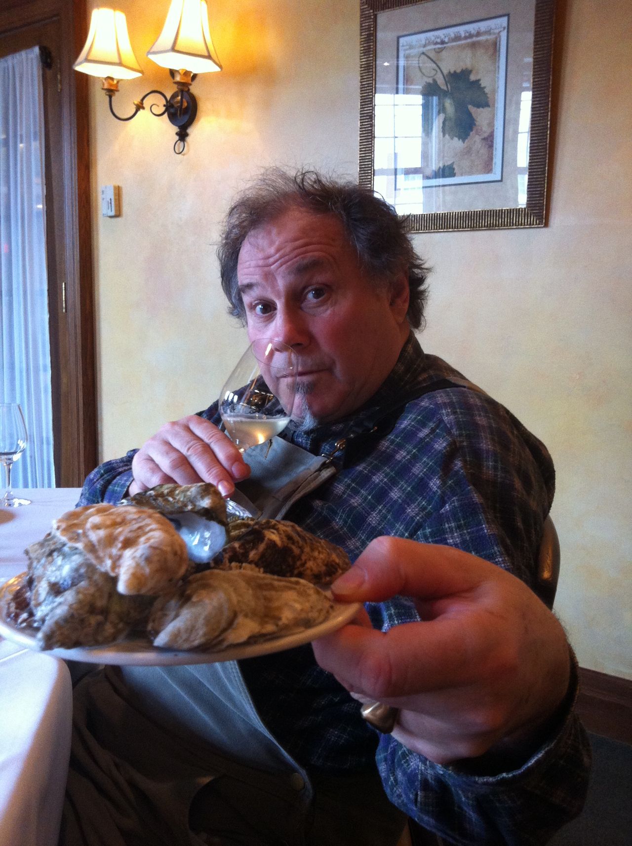 Rodney Clark holds a plate of oysters out to the camera