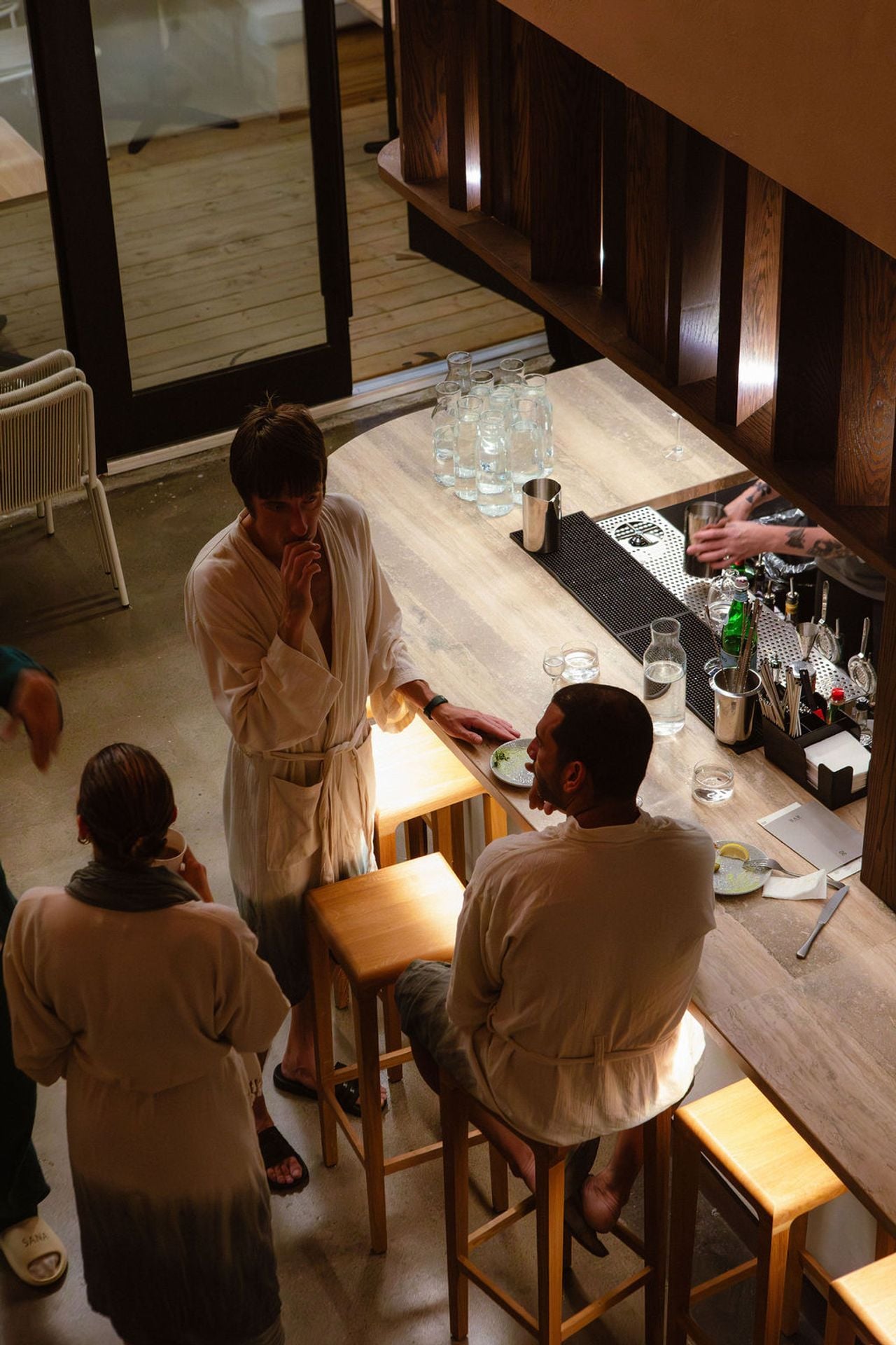 People gather at the bar at Sana