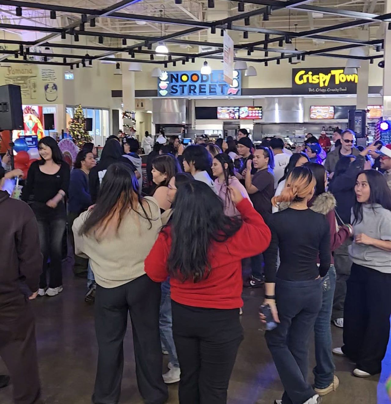 People dance in the Seafood City food court