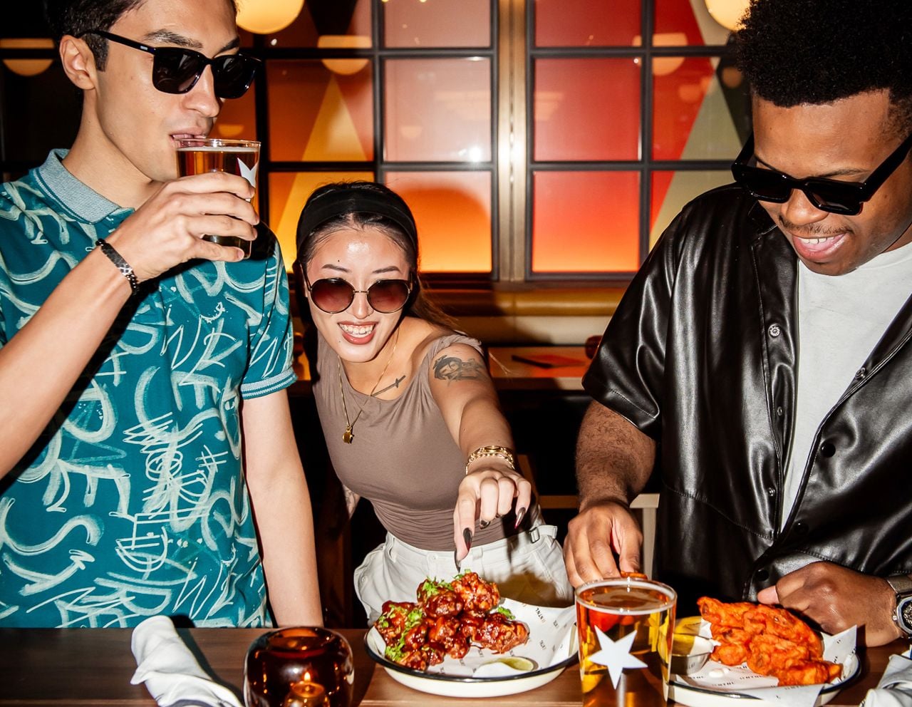 People enjoy snacks and drinks at a bar's happy hour