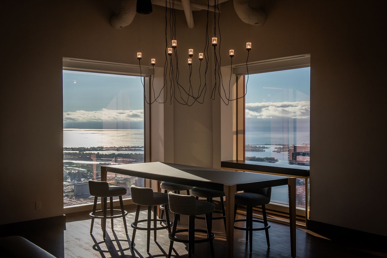 A communal table at SixtyEight with views of Lake Ontario