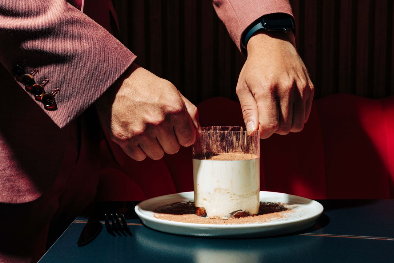 Classic tiramisu arrives wrapped in a sheet of acetate that’s peeled away tableside for a playful, dramatic splat