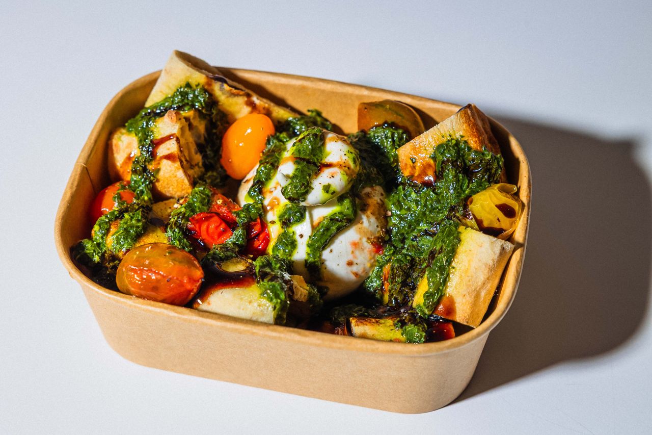 A burrata and tomato salad with pesto