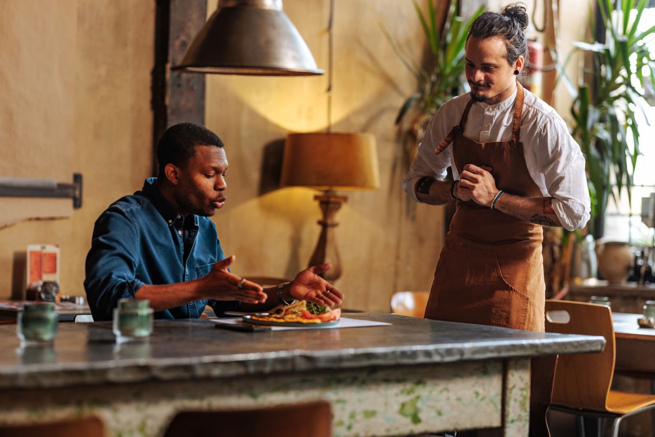 Angry customer with nervous waiter