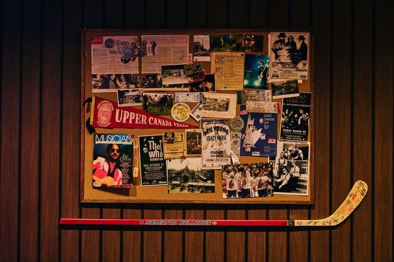 A cork board covered with vintage concert tickets and newspaper clippings