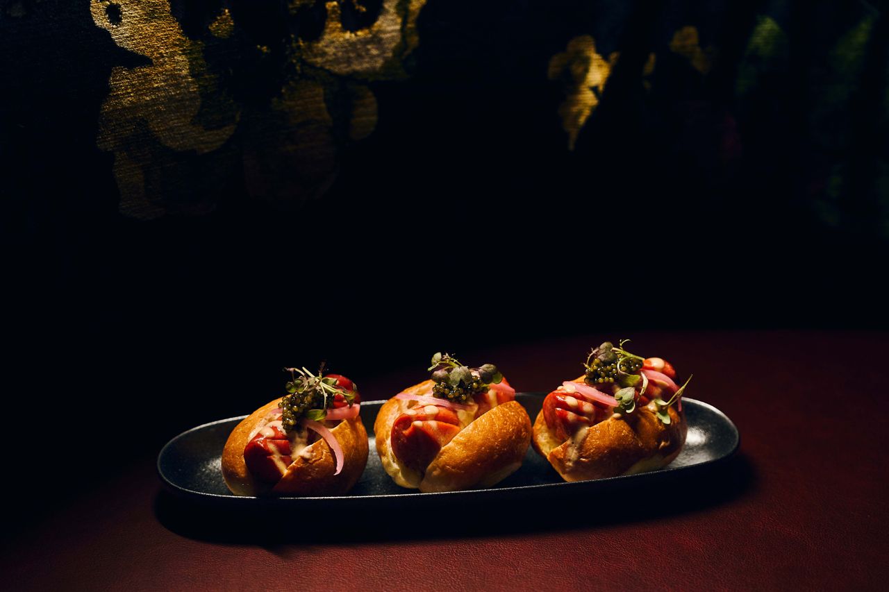 Three mini Wagyu hot dogs topped with caviar