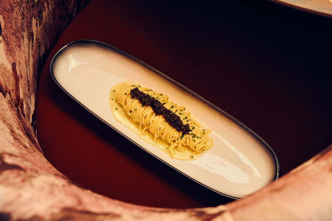 Pasta topped with chives and caviar