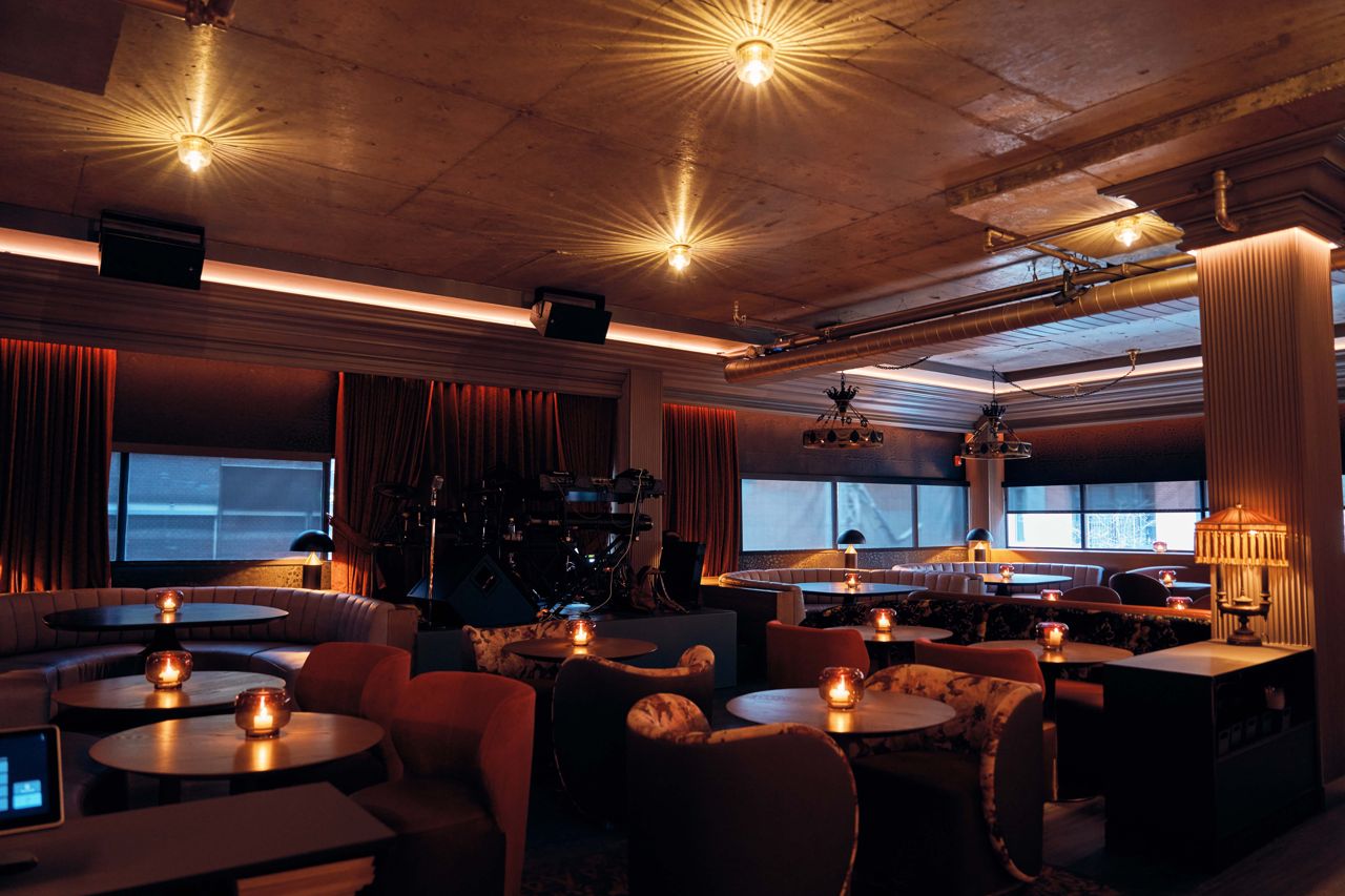 The dining room of the Powder Room, featuring a stage for live entertainment