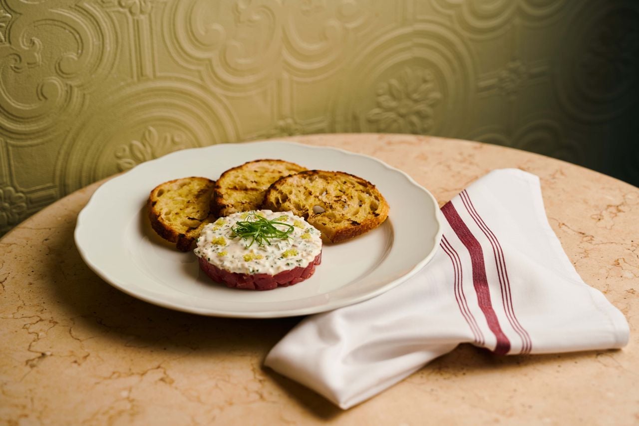 Grilled Thuet sourdough rounds are topped with Canadian bluefin tuna tartare, finished with a crème fraîche relish blended with ginger and chives and bright pearls of finger lime