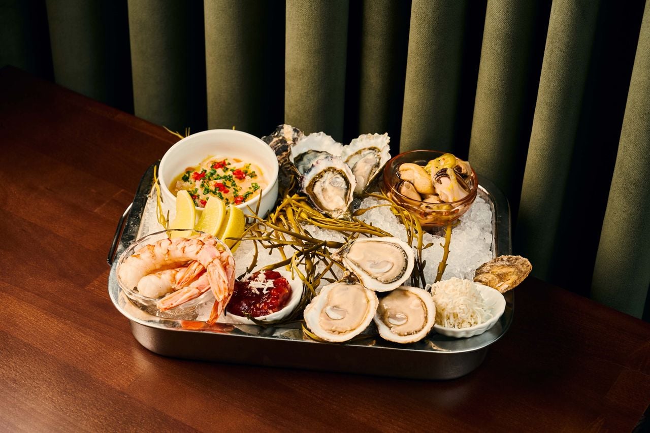 A tray of raw seafood on ice