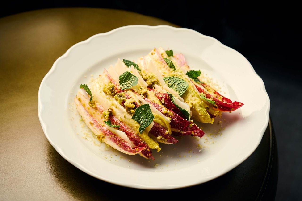 Leaves of red and white endive are tossed in a malt-vinegar vinaigrette punched up with pistachios and mint
