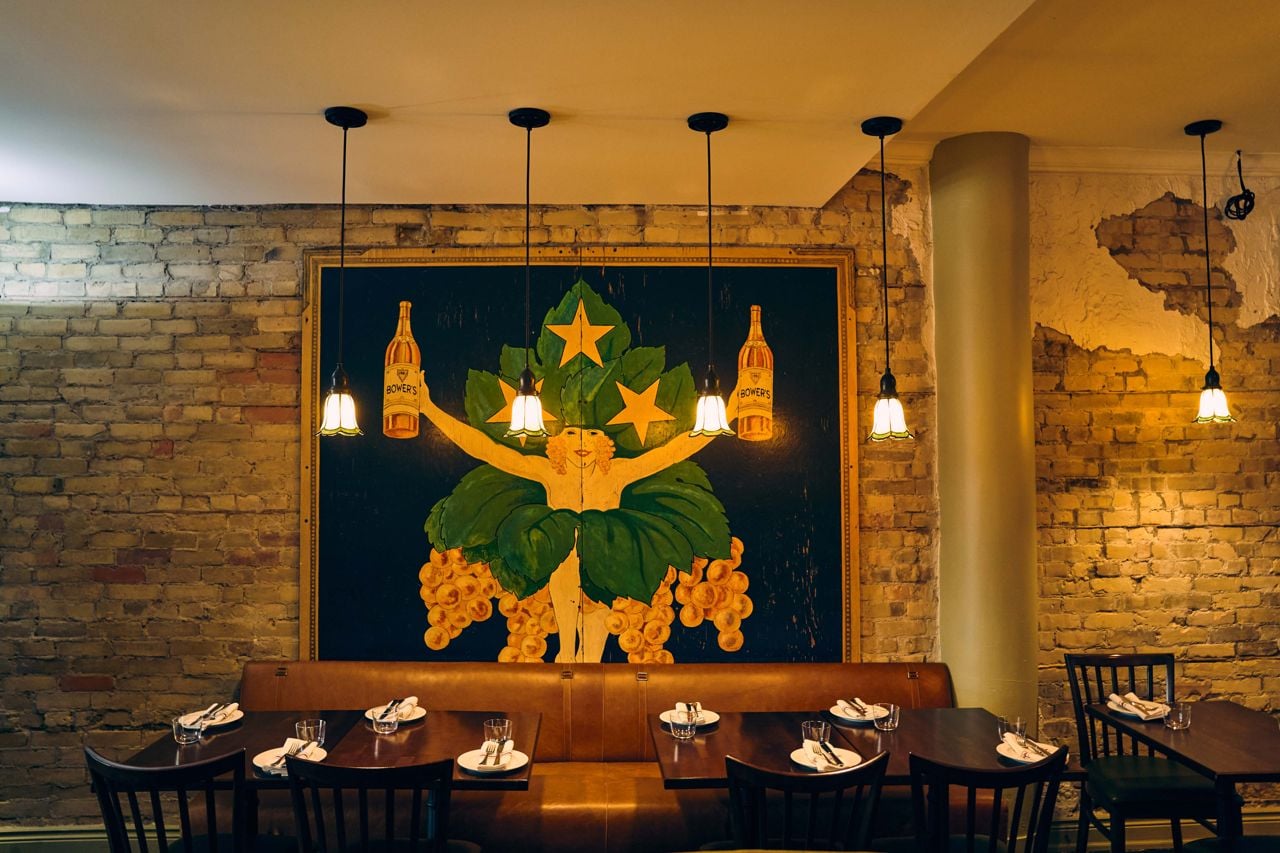 Four-top tables and exposed brick in the dining room of the Seahorse Restaurant
