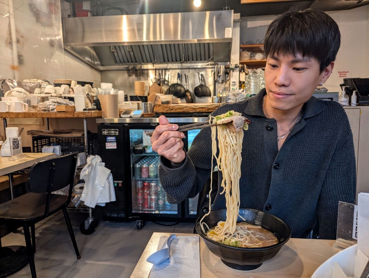 Chef Jayden Park uses chopsticks to eat ramen