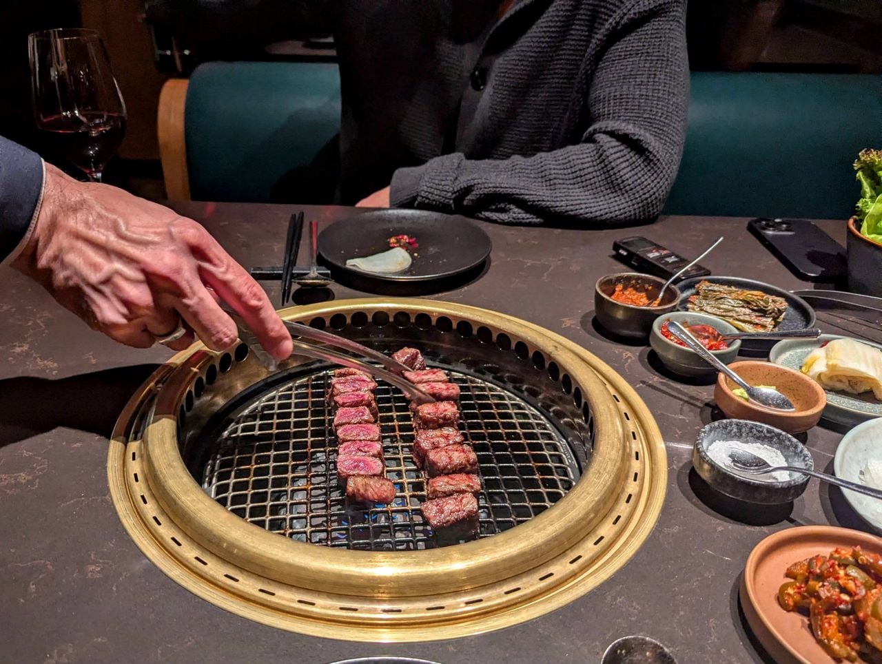 A server grills wagyu beef on the barbecue at Takja BBQ