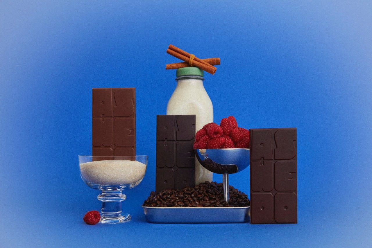 Chocolate bars, cacao beans, bottles of milk fruit and sugar