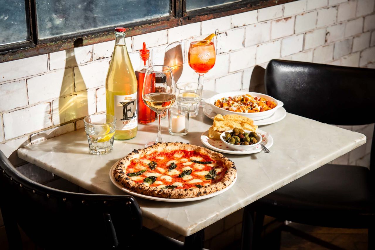 A spread of pizza and drinks at Bar Libretto