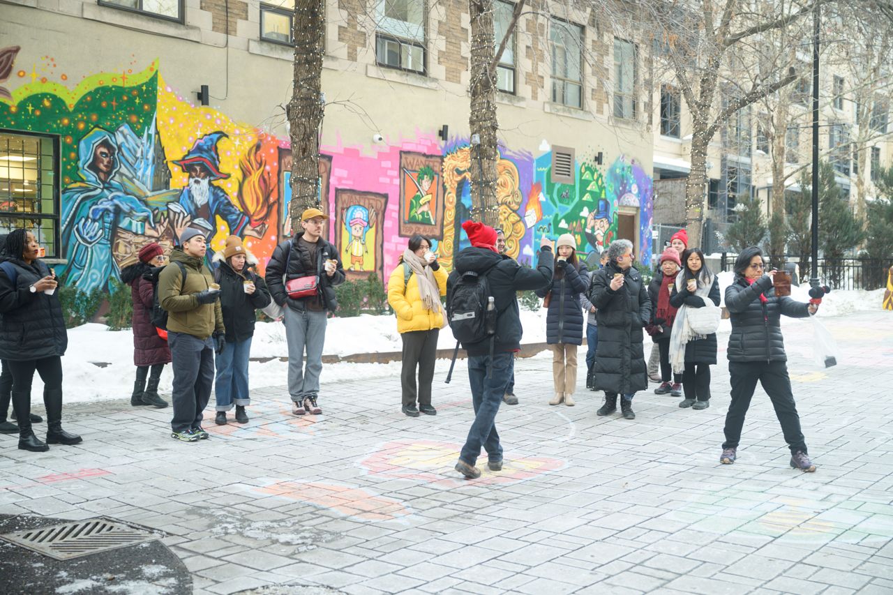 People are led on a walking tour of downtown Toronto