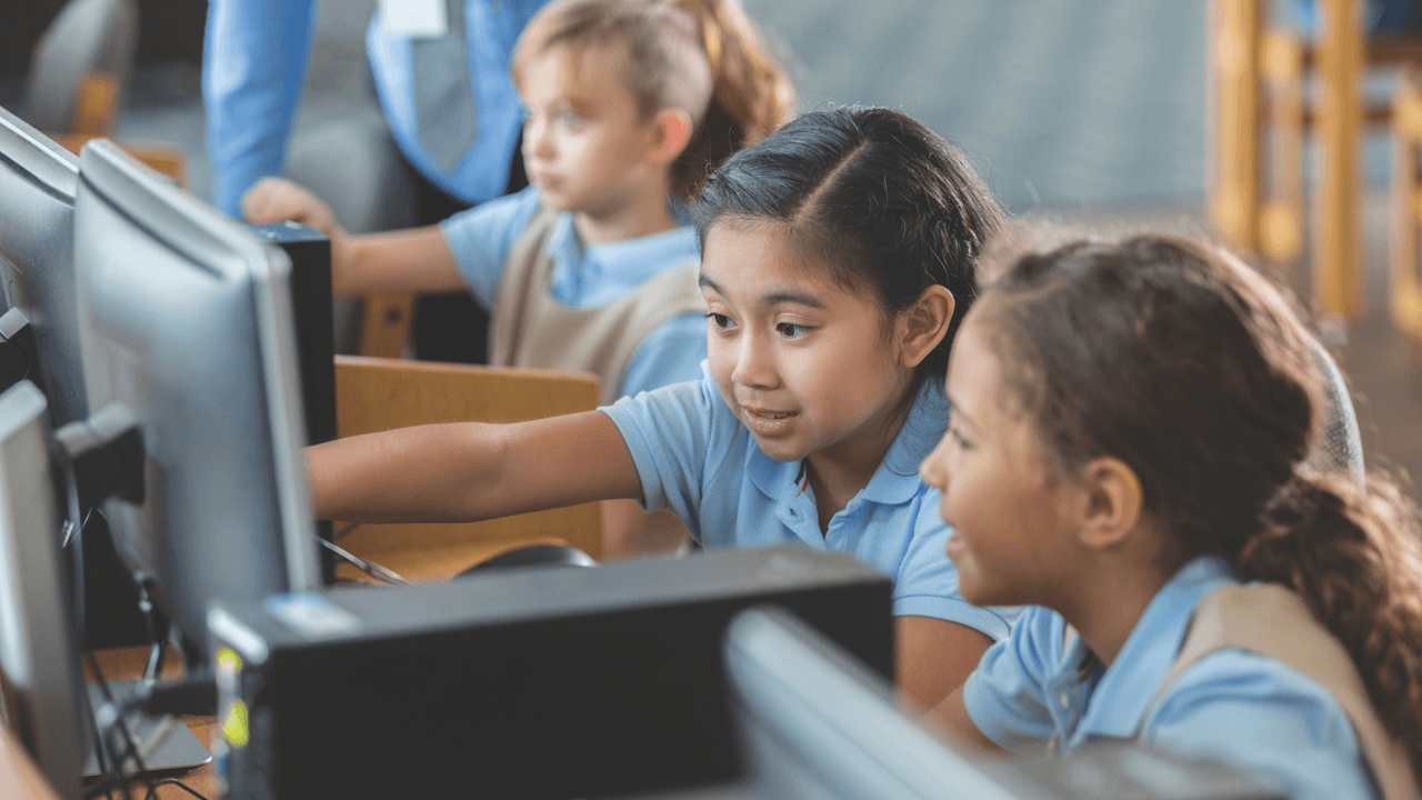 Closeup of kids in a computer lab at school.