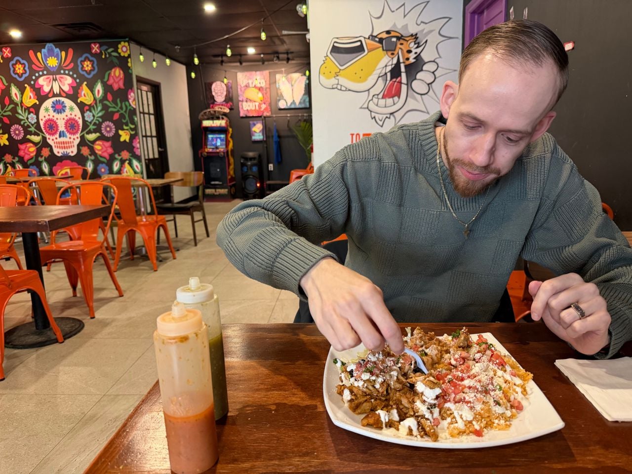 Chef Robert Balint digs into a burrito bowl at Contigo Taco Bar