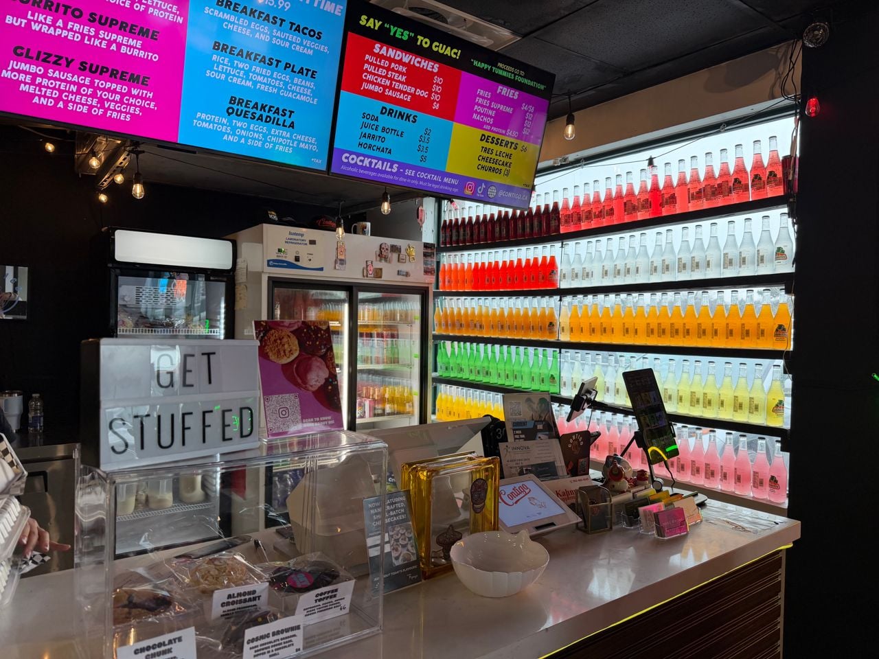 The counter and fridge filled with Jarritos at Contigo Taco Bar