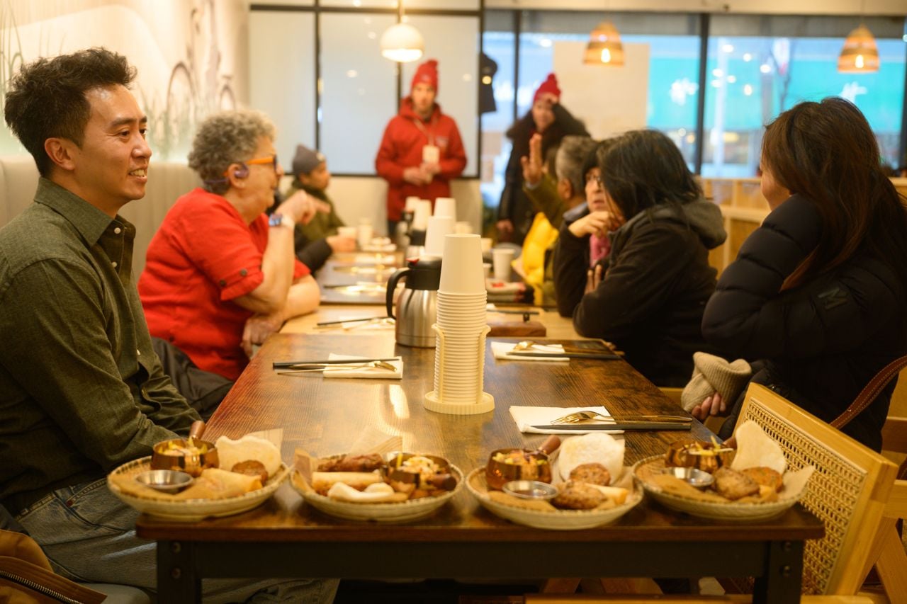 People enjoy a stop on food tour in downtown Toronto