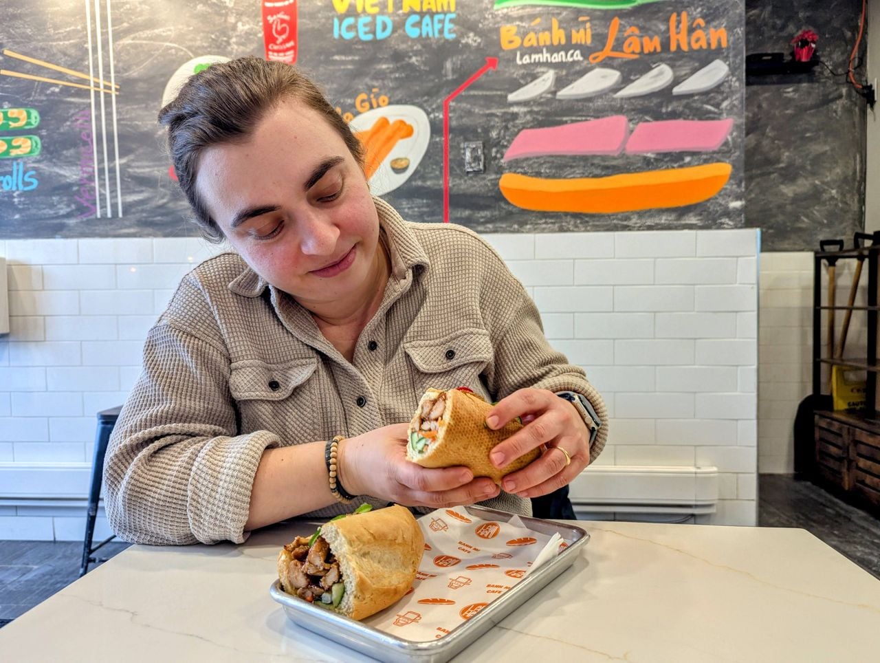 Chef Shauna Godfrey holds one half of a banh mi