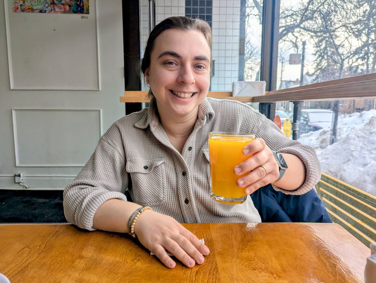 Chef Shauna Godfrey holds up a glass of tangerine juice
