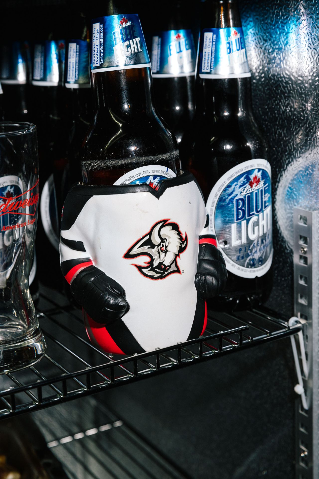 Beer bottles dressed in Buffalo Sabres shirts