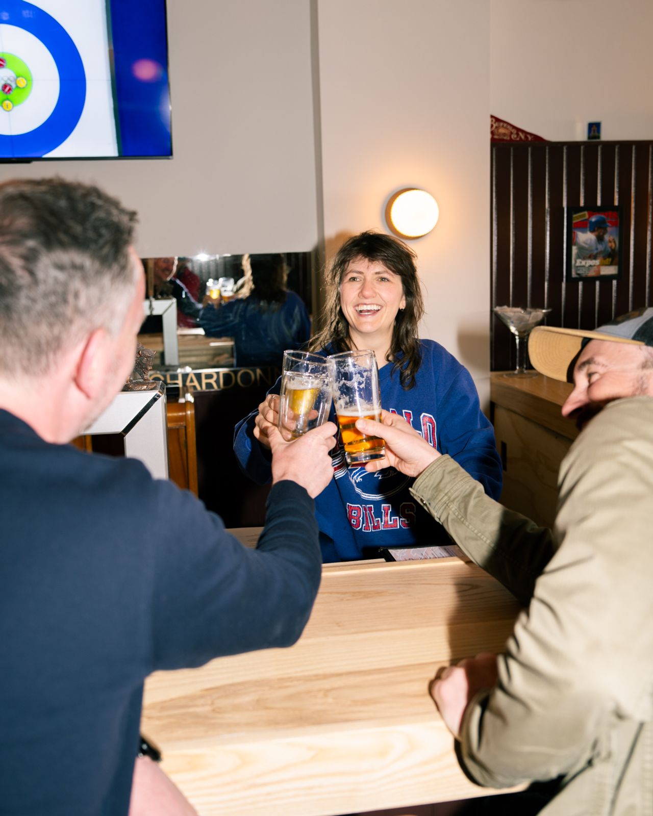 People cheers with glasses of beer at the Elmwood